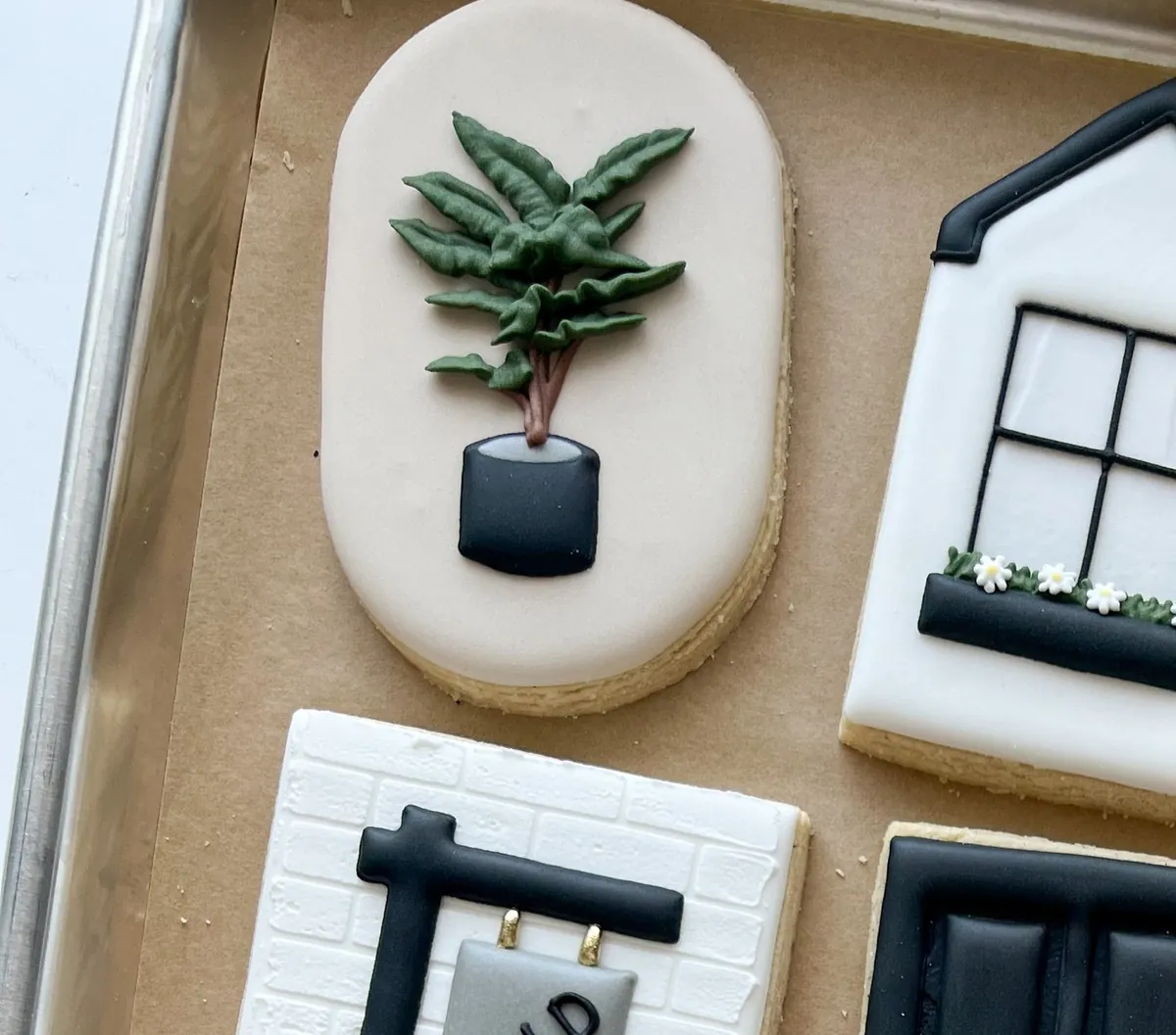 Housewarming cookies with an iced plant, window and door details