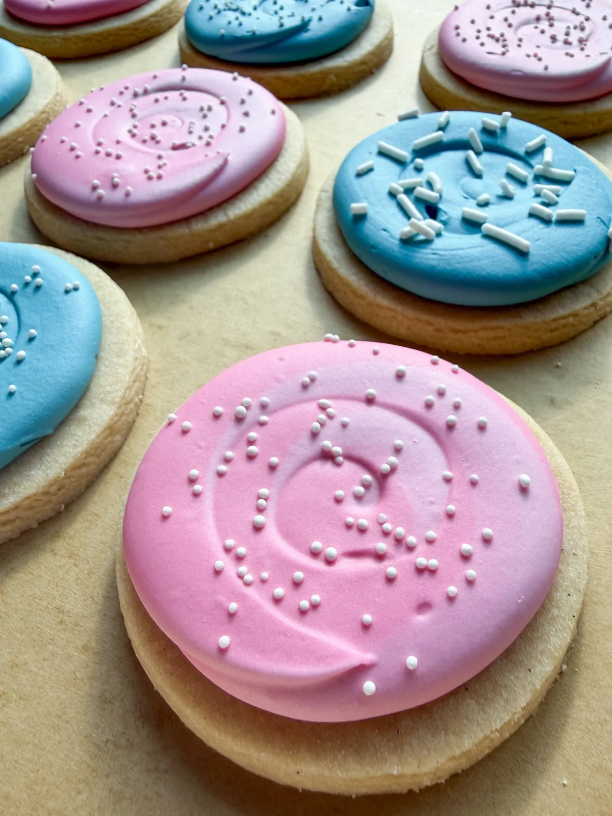 Pink and blue round cookies with white nonpareils