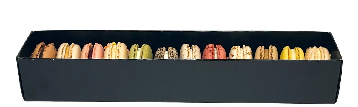 Mixed macarons arranged in a black gift box